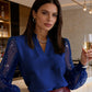 Top con scollo a V e maniche trasparenti con paillettes