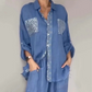 Set composto da una camicetta da donna con paillettes e un paio di pantaloni larghi