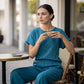 Set composto da top a maniche corte e pantaloni a gamba larga da donna